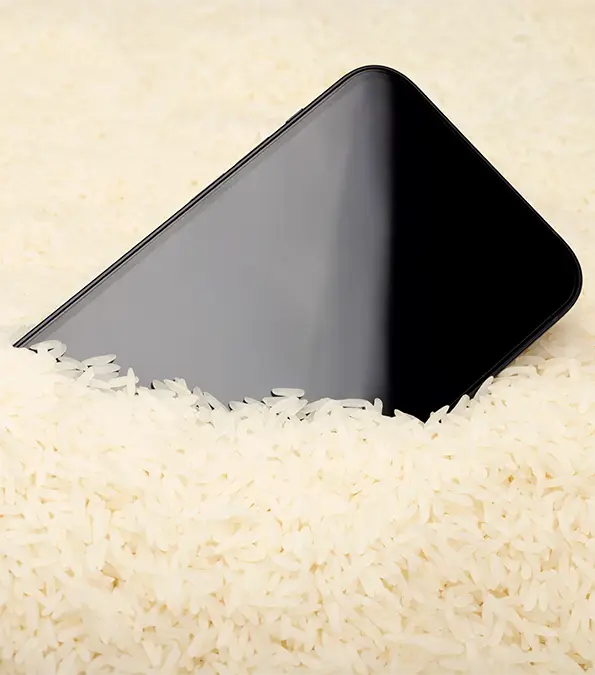 Apple warns users against putting their iPhones in a bowl of rice / Arthit Pornpikanet / Getty