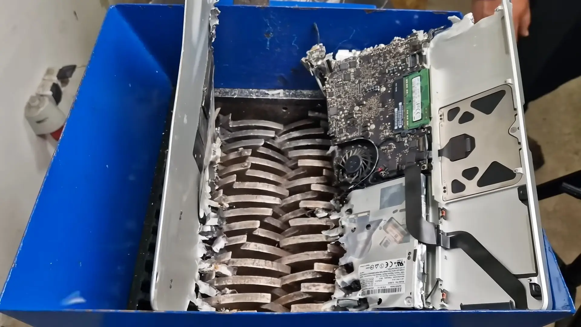 The MacBook was mauled apart when it passed through the shredding machine opened up (YouTube/Gojzer)