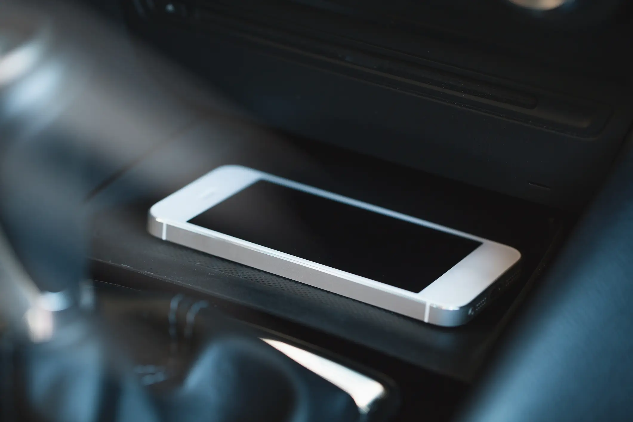 A phone left inside a car, atop a wireless charger (Getty Images)
