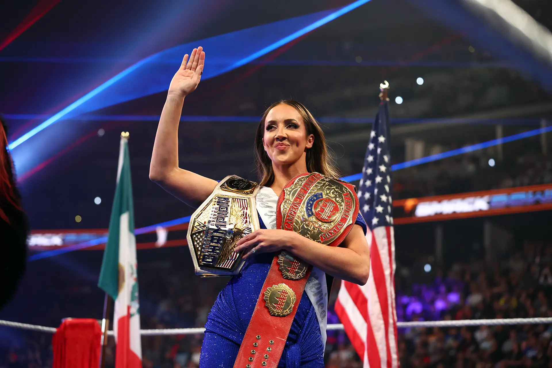 Chelsea Green with WWE and AAA Championships, WWE (via Getty Images)