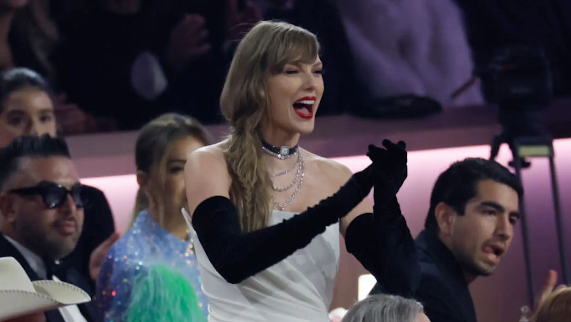 Did Taylor Swift Bring A *Literal* Fan To The Grammys To Gossip In Private?