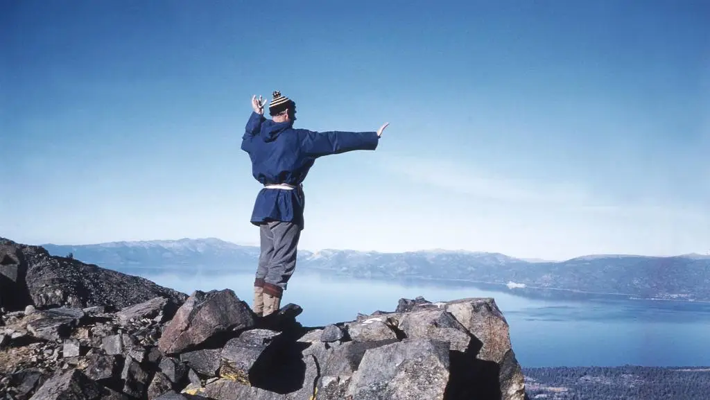Dr King stands atop a mountain.