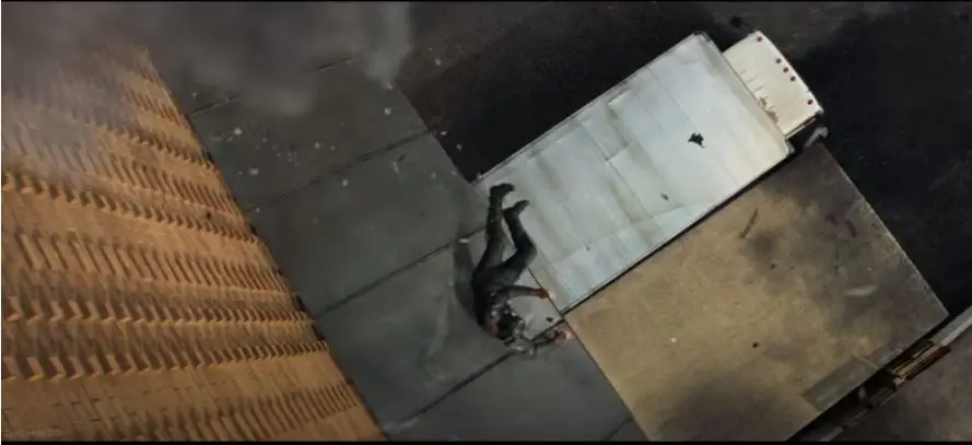 On the way to the ground, he hits an awning and then a truck.