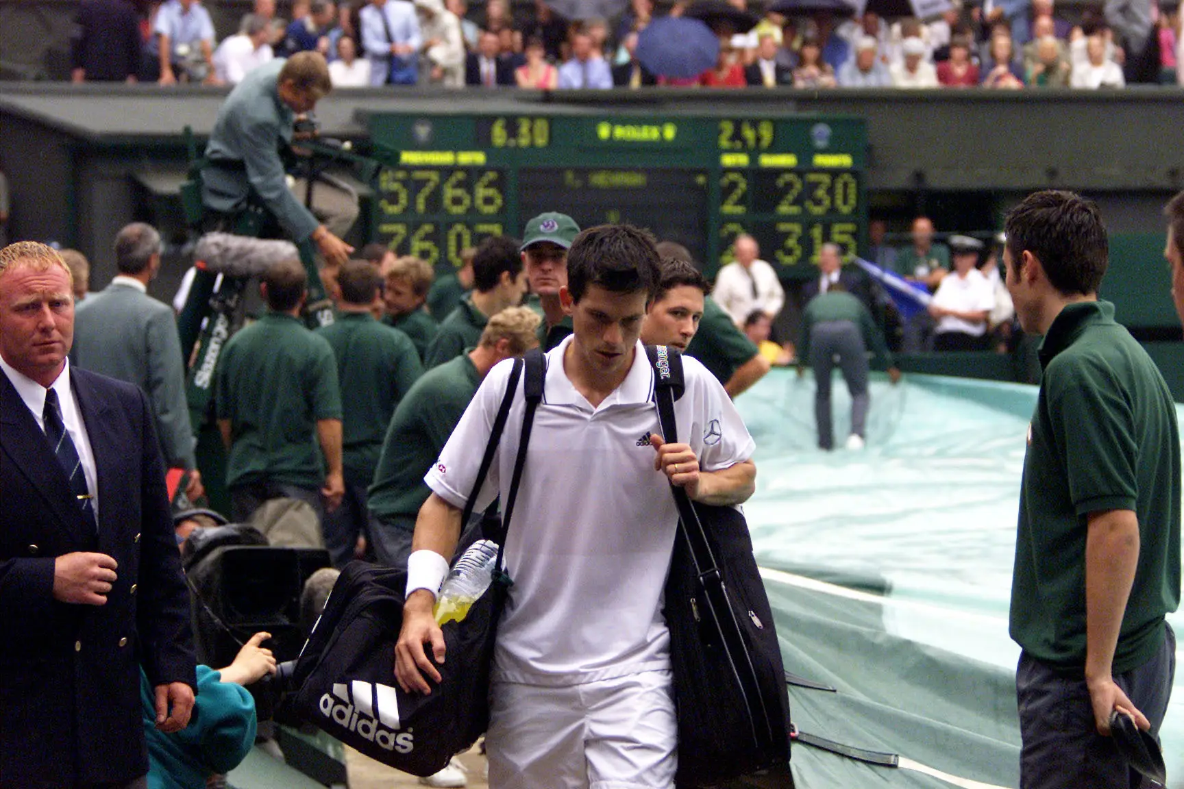 Henman walks off for the rain delay that changed the match. Image: PA Images